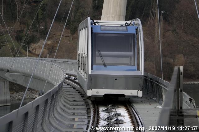 The cable stay bridge over the river Inn : Vehicle on a test run on the bridge.